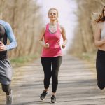 Three adults jogging on a park path, embracing a healthy and active lifestyle.
